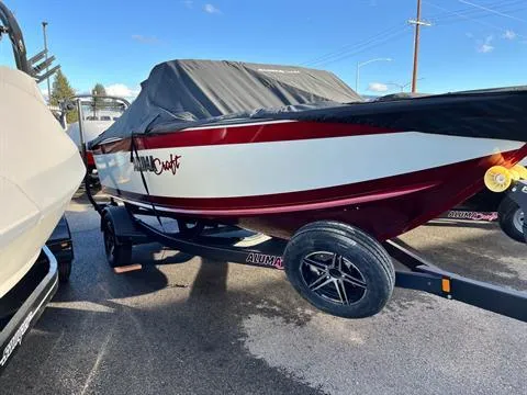 Slide: The Image of 2023 Alumacraft Trophy 185 boat with cover on trailer, parked outdoors. - 5