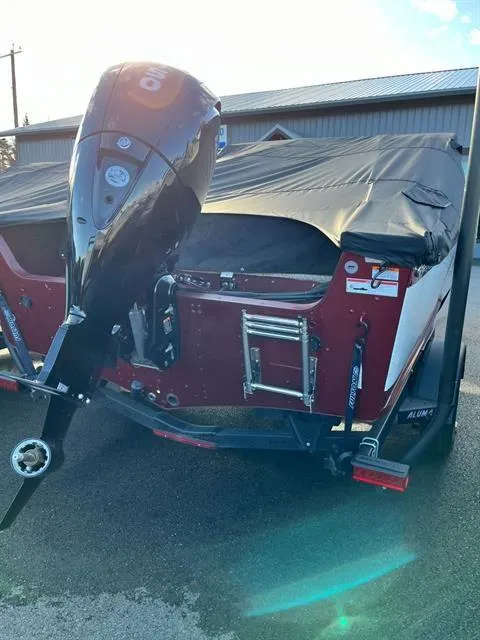 Slide: The Image of 2023 Alumacraft Trophy 185 boat with covered motor, parked outdoors. - 6