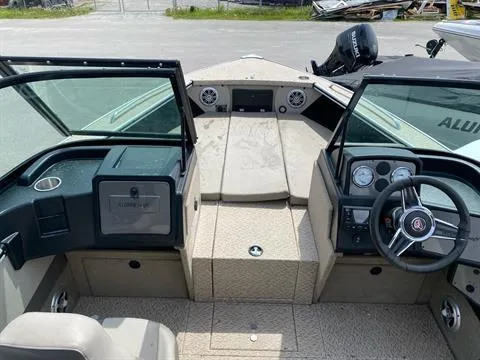 Slide: The Image of 2023 Alumacraft Trophy 185 boat interior with steering console and seating. - 7