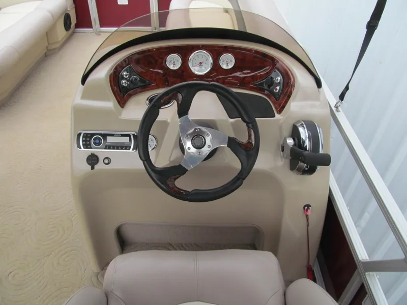 Slide: The Image of 2014 Sun Tracker Party Barge 20 DLX steering console with gauges and controls. - 6
