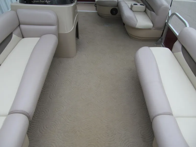Slide: The Image of 2014 Sun Tracker Party Barge 20 DLX interior with beige seating and carpet. - 7