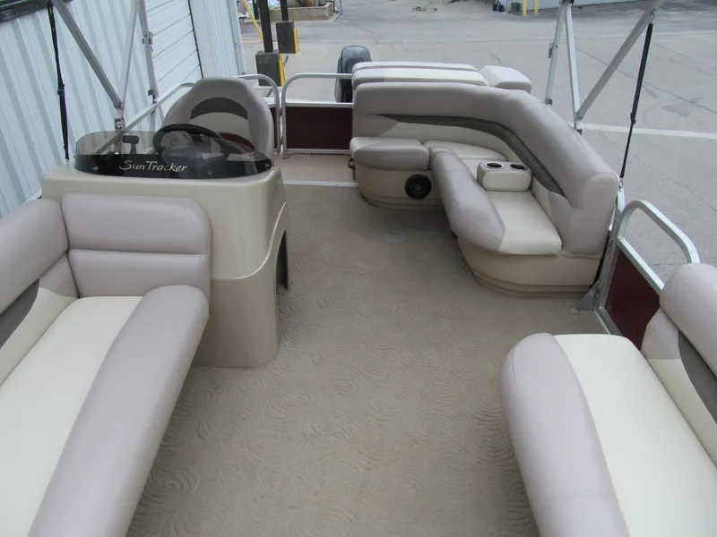Slide: The Image of 2014 Sun Tracker Party Barge 20 DLX interior with spacious seating and steering console. - 8