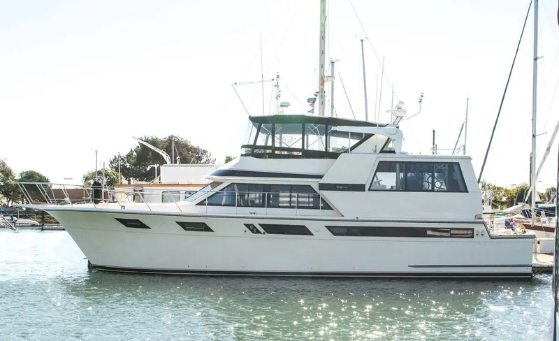 Slide: The Image of 1986 Californian 55 Cockpit Motor Yacht docked in sunny marina. - 1