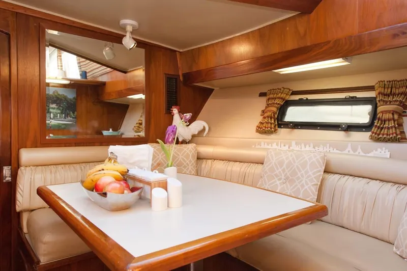 Slide: The Image of Interior of 1986 Californian 55 Cockpit Motor Yacht with dining area and fruit bowl. - 12