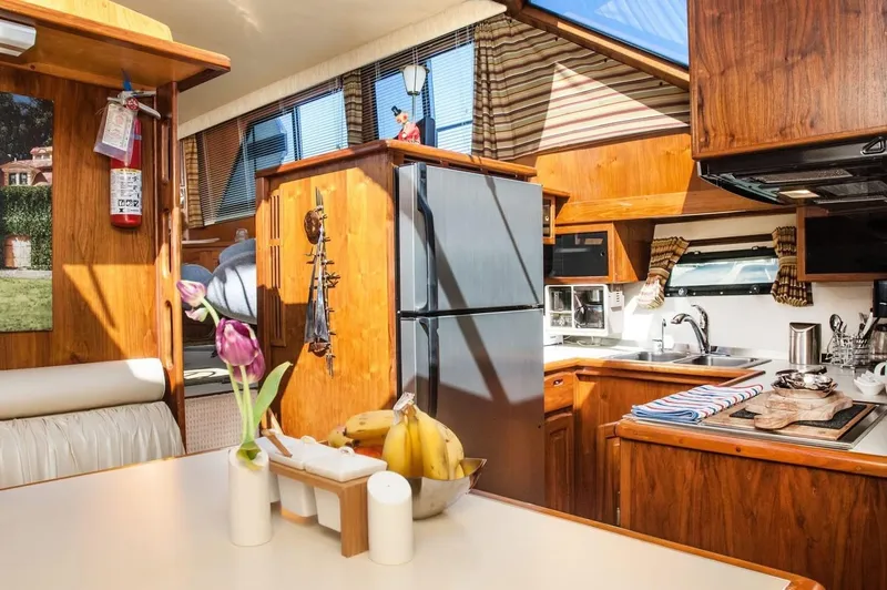 Slide: The Image of Interior of 1986 Californian 55 Cockpit Motor Yacht with kitchen and dining area. - 13
