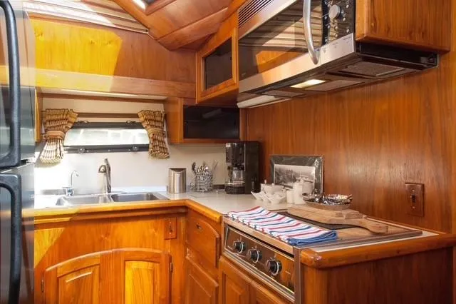 Slide: The Image of 1986 Californian 55 Cockpit Motor Yacht kitchen with wood cabinetry and modern appliances. - 14