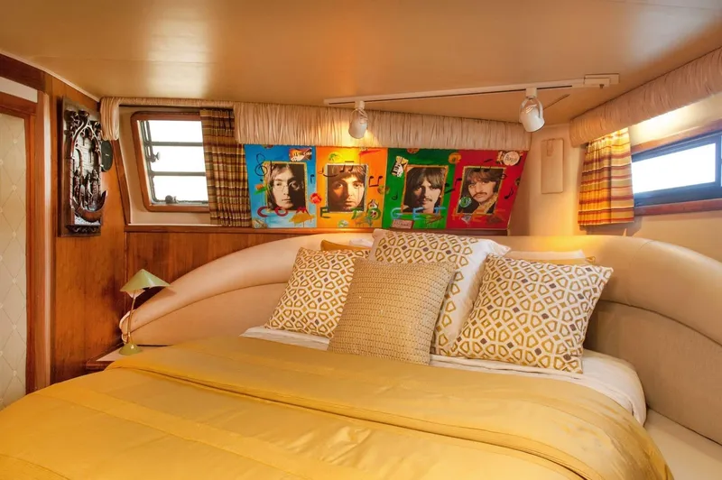 Slide: The Image of Luxurious bedroom in 1986 Californian 55 Cockpit Motor Yacht with vibrant pop art decor. - 18