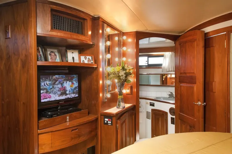 Slide: The Image of Luxurious interior of 1986 Californian 55 Cockpit Motor Yacht with wood paneling and modern amenities. - 19
