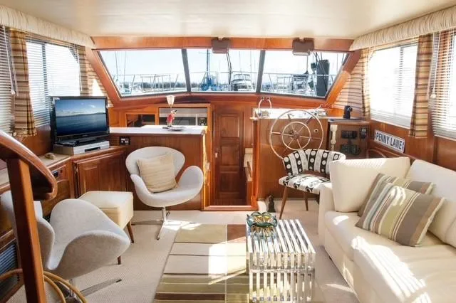 Slide: The Image of Luxurious interior of 1986 Californian 55 Cockpit Motor Yacht with elegant seating and decor. - 2