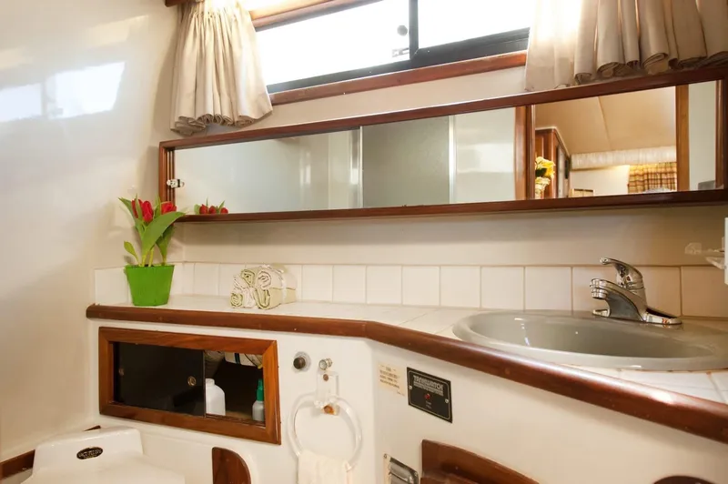 Slide: The Image of Interior of 1986 Californian 55 Cockpit Motor Yacht bathroom with sink and mirror. - 20