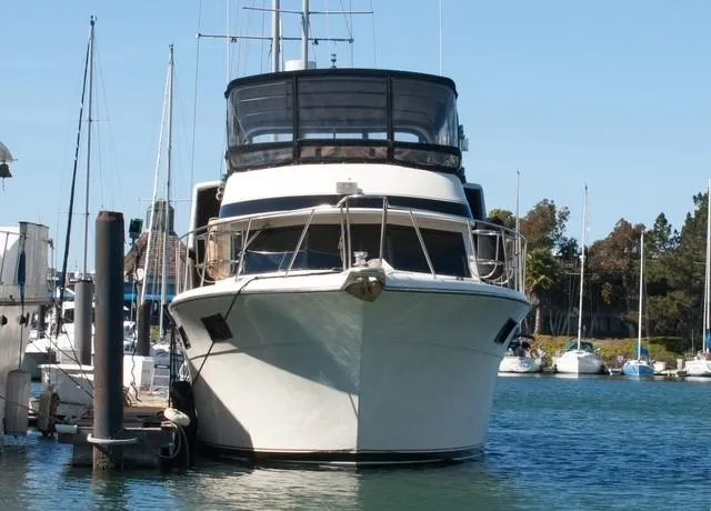 Slide: The Image of 1986 Californian 55 Cockpit Motor Yacht docked in a marina. - 23