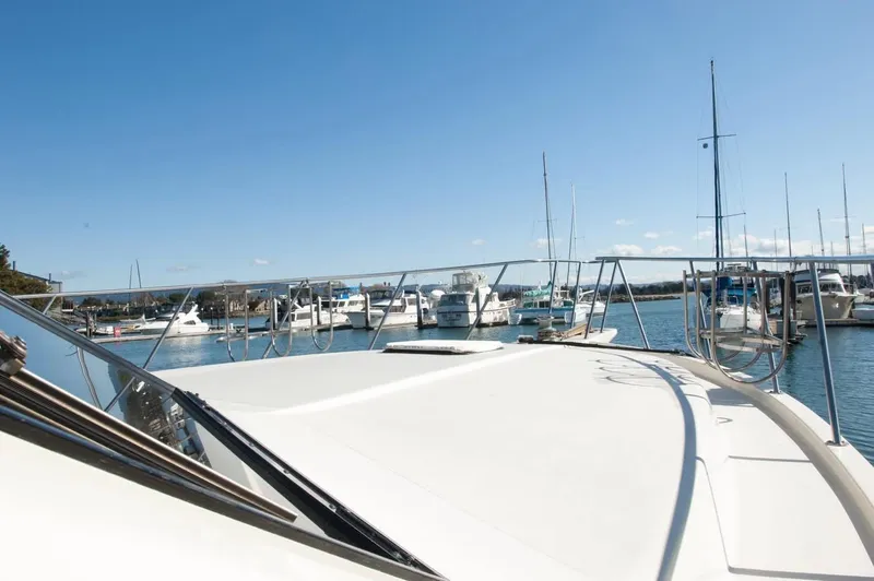 Slide: The Image of 1986 Californian 55 Cockpit Motor Yacht docked in a sunny marina. - 25