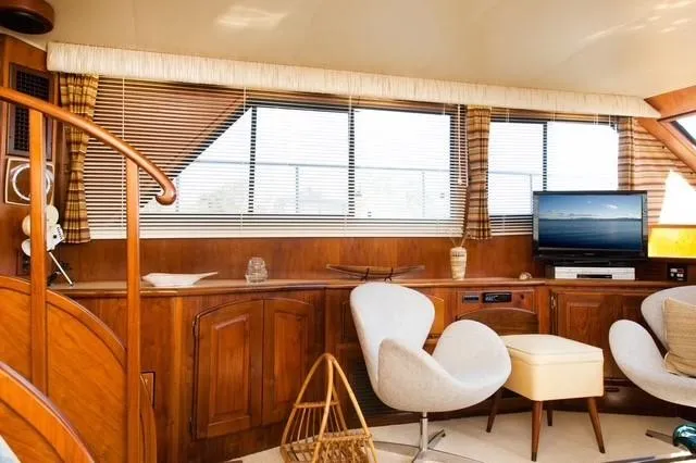 Slide: The Image of Interior of 1986 Californian 55 Cockpit Motor Yacht with elegant wood paneling and modern seating. - 7