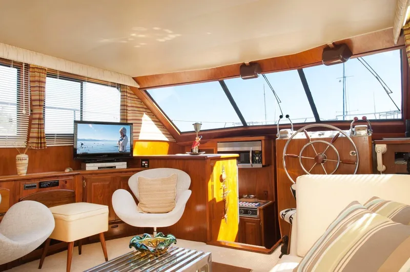 Slide: The Image of Luxurious interior of 1986 Californian 55 Cockpit Motor Yacht with modern furnishings and helm. - 9