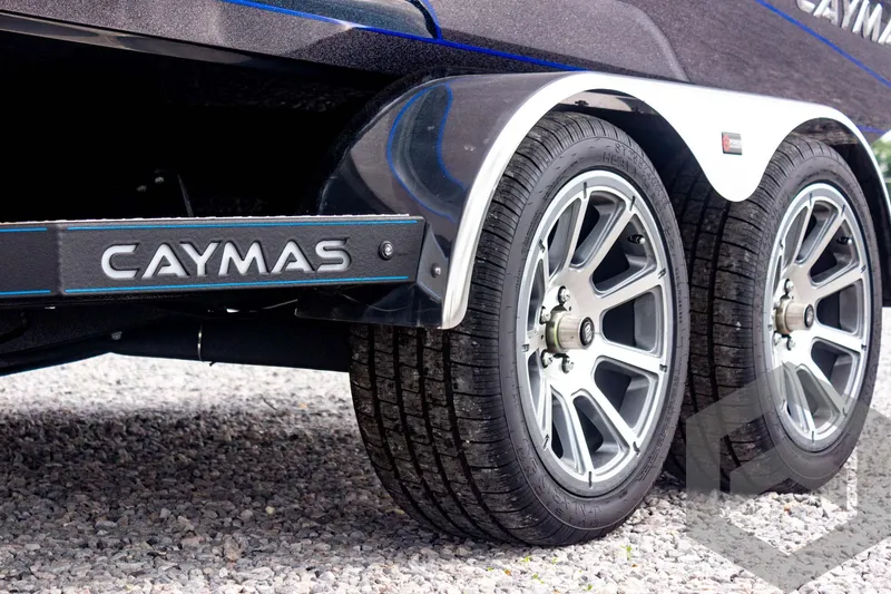 Slide: The Image of 2025 Caymas CX 21 PRO trailer wheels on gravel surface. - 11