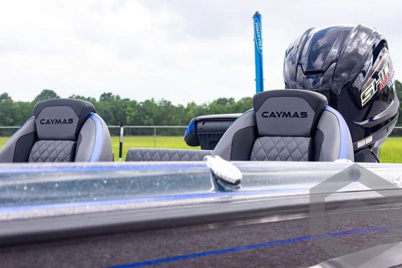 Slide: The Image of 2025 Caymas CX 21 PRO boat seats and engine, outdoor setting. - 13