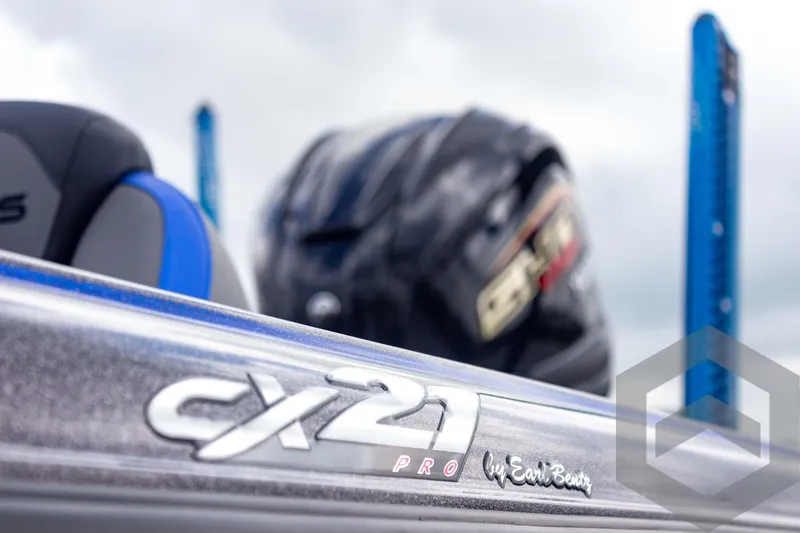 Slide: The Image of 2025 Caymas CX 21 PRO boat detail with helmet in background. - 15