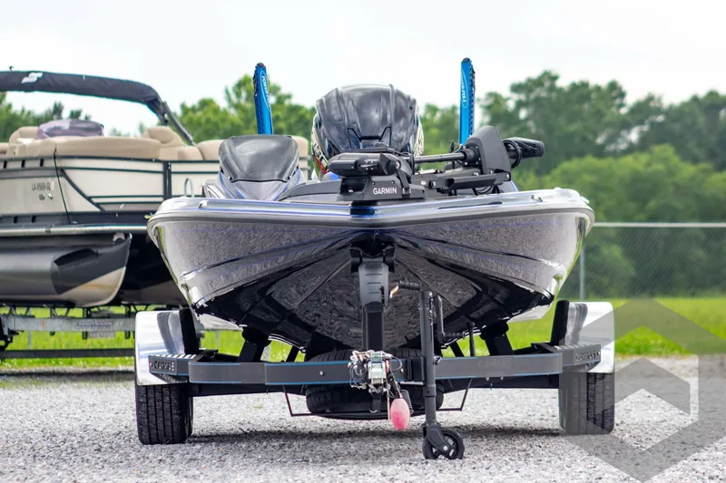 Slide: The Image of 2025 Caymas CX 21 PRO boat on trailer, front view, parked outdoors. - 2