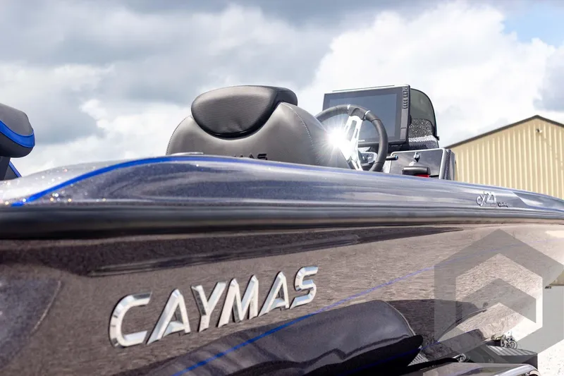 Slide: The Image of 2025 Caymas CX 21 PRO boat, sleek design, close-up view, under cloudy sky. - 21