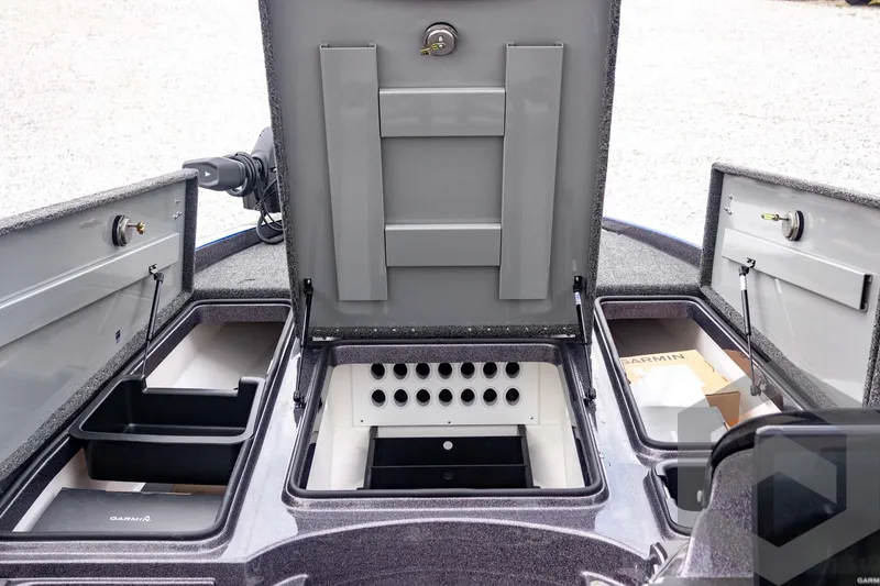 Slide: The Image of 2025 Caymas CX 21 PRO boat storage compartments and control panel. - 25