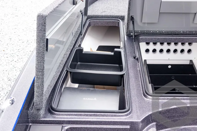 Slide: The Image of 2025 Caymas CX 21 PRO boat storage compartments with organized trays and holders. - 26