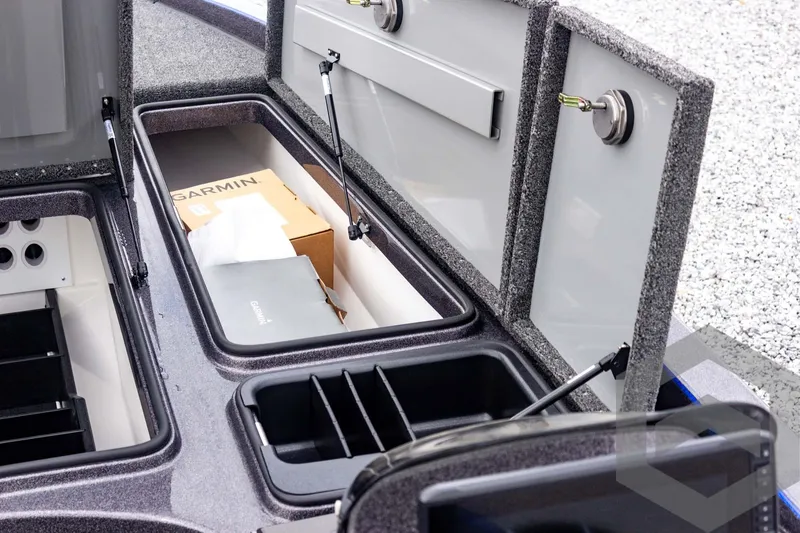 Slide: The Image of 2025 Caymas CX 21 PRO boat storage compartments with Garmin equipment. - 28