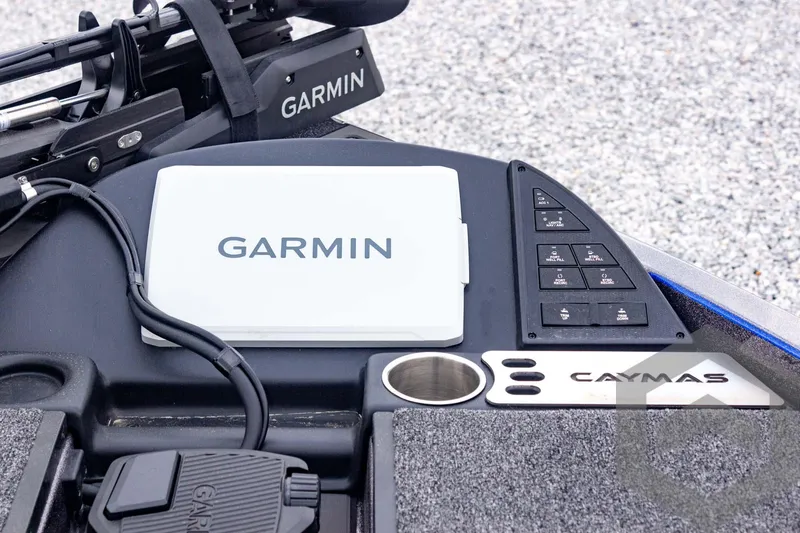 Slide: The Image of 2025 Caymas CX 21 PRO boat dashboard featuring Garmin electronics and control panel. - 29