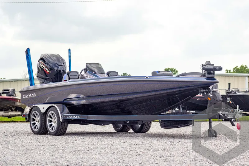 Slide: The Image of 2025 Caymas CX 21 PRO boat on trailer, sleek design, dual motors, outdoor setting. - 3
