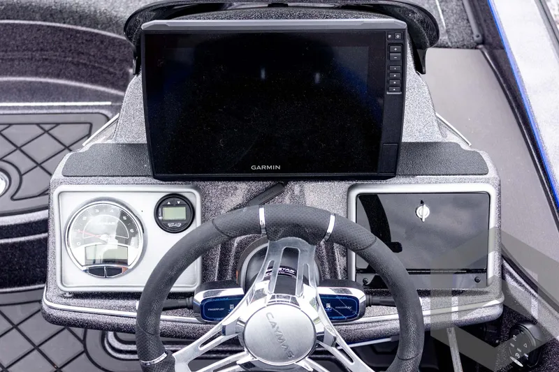 Slide: The Image of 2025 Caymas CX 21 PRO boat dashboard with Garmin display and steering wheel. - 38