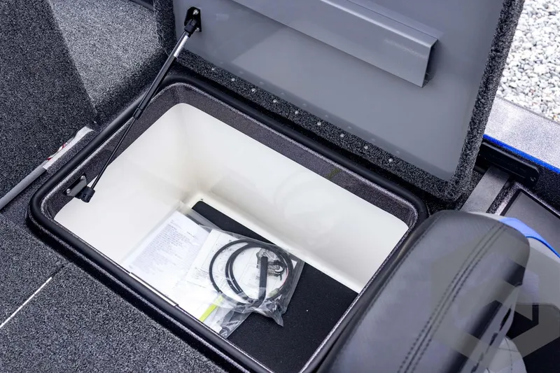Slide: The Image of 2025 Caymas CX 21 PRO storage compartment with documents and cables inside. - 47