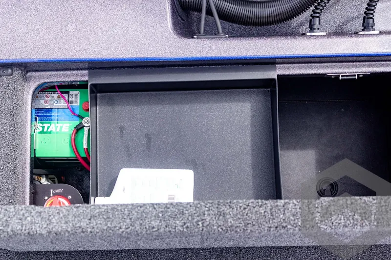 Slide: The Image of 2025 Caymas CX 21 PRO boat battery compartment with wiring and storage space. - 48