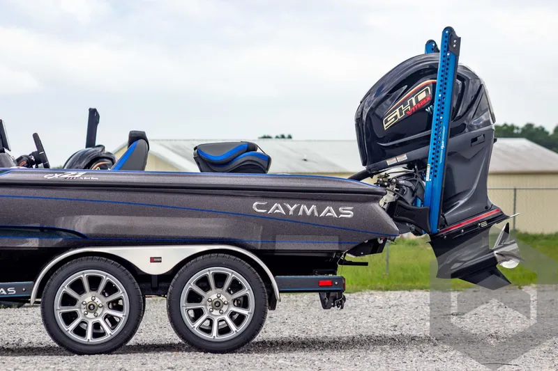 Slide: The Image of 2025 Caymas CX 21 PRO boat with dual axle trailer and powerful outboard motor. - 7