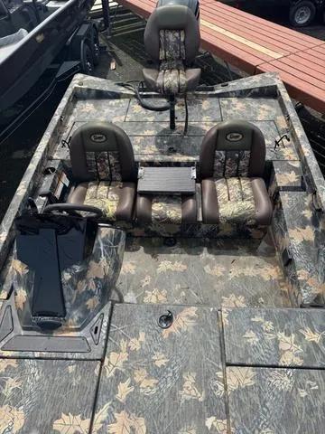 Slide: The Image of 2015 Ranger RT 188 boat with camouflage seats and deck, docked near a wooden pier. - 3