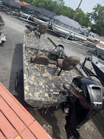 Slide: The Image of 2015 Ranger RT 188 boat with camouflage design and Mercury outboard motor in a marina. - 6