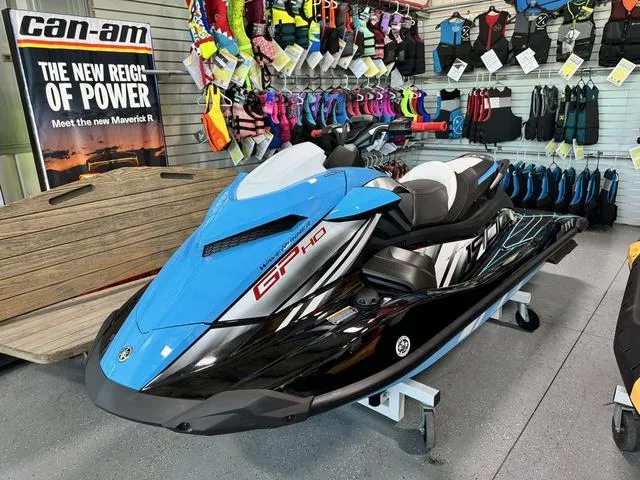 Slide: The Image of 2024 Yamaha WaveRunners GP HO with Audio, blue and black, displayed in a showroom. - 1
