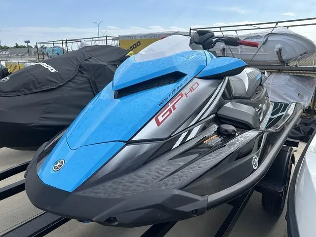 Slide: The Image of 2024 Yamaha WaveRunners GP HO with Audio, blue and black jet ski on display. - 12