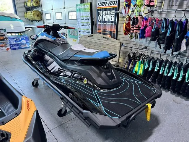 Slide: The Image of 2024 Yamaha WaveRunners GP HO with Audio in showroom, surrounded by water sports gear. - 2