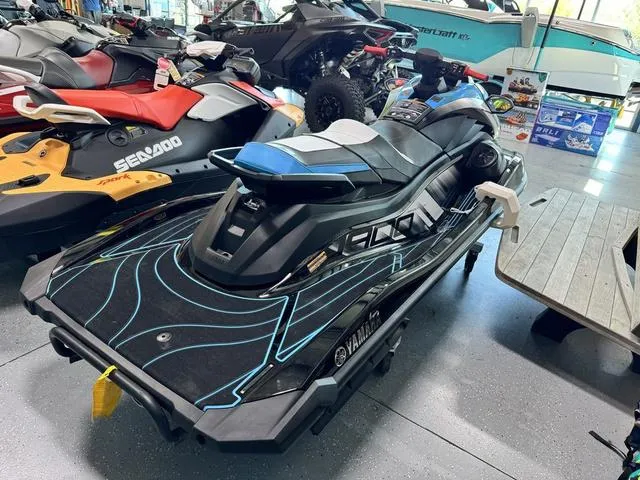 Slide: The Image of 2024 Yamaha WaveRunners GP HO with Audio, black and blue, displayed in showroom. - 4
