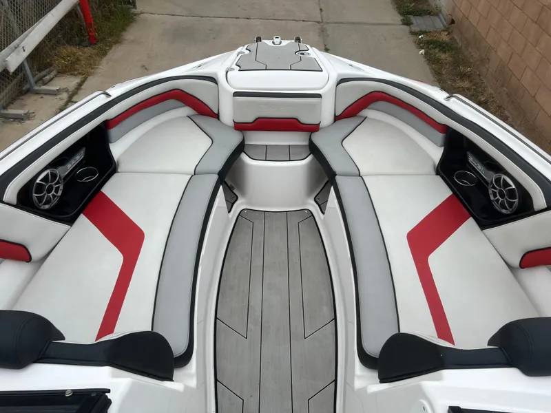 Slide: The Image of 2020 Yamaha Boats 242X interior with red and gray seating, sleek design. - 10