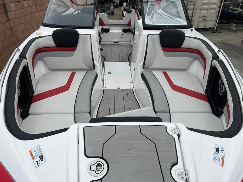 Slide: The Image of 2020 Yamaha Boats 242X interior with red and gray seating, modern design. - 17