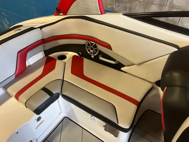 Slide: The Image of 2020 Yamaha Boats 242X interior seating with red and white upholstery and speaker detail. - 18