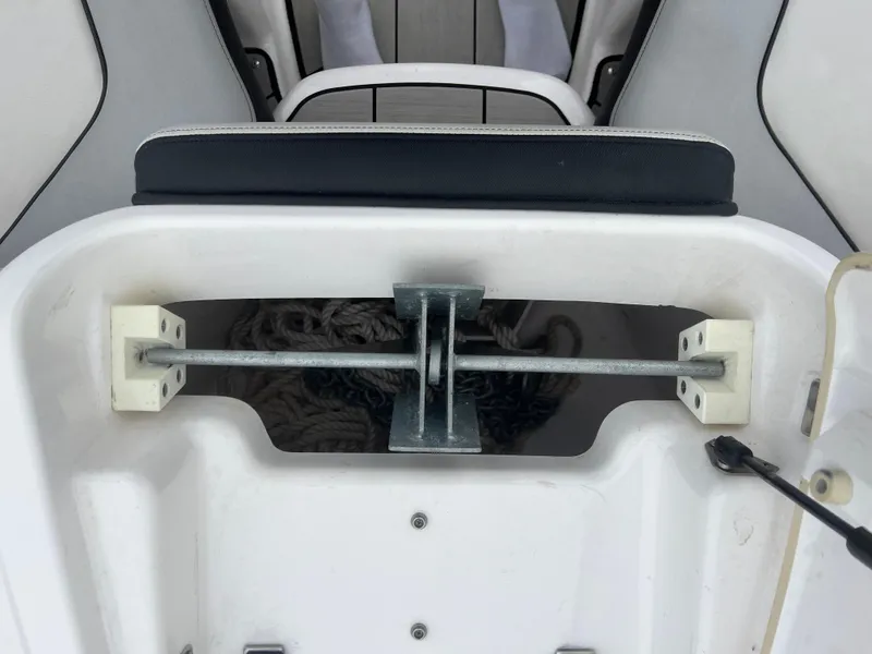 Slide: The Image of 2020 Yamaha Boats 242X anchor storage compartment with secured anchor and rope. - 31