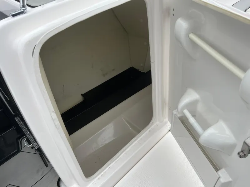 Slide: The Image of Open storage compartment on a 2020 Yamaha Boats 242X. - 32