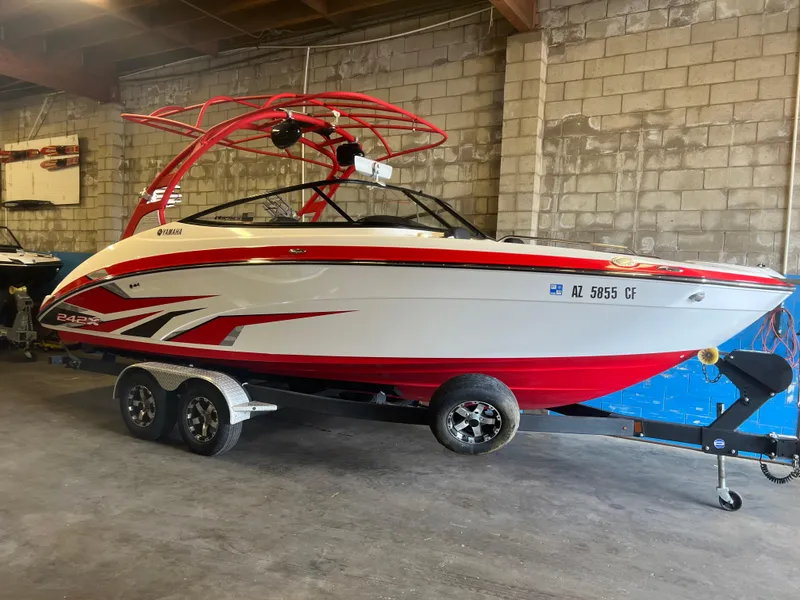 Slide: The Image of 2020 Yamaha Boats 242X in a garage, red and white design, on a trailer. - 9
