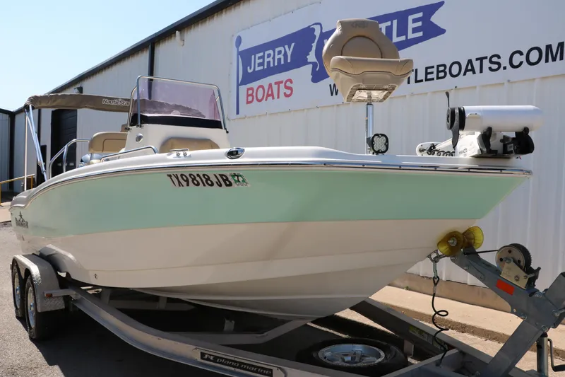 Slide: The Image of 2020 NauticStar 211 Hybrid boat on trailer at Jerry Boats dealership. - 10