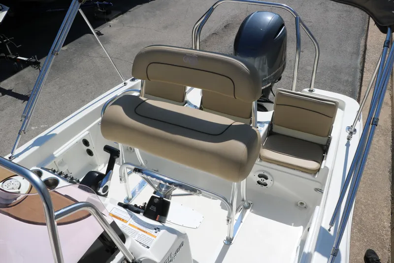 Slide: The Image of 2020 NauticStar 211 Hybrid boat on trailer at dealership. - 11