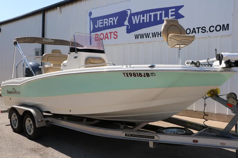 Slide: The Image of 2020 NauticStar 211 Hybrid boat on trailer at Jerry Whittle Boats dealership. - 2