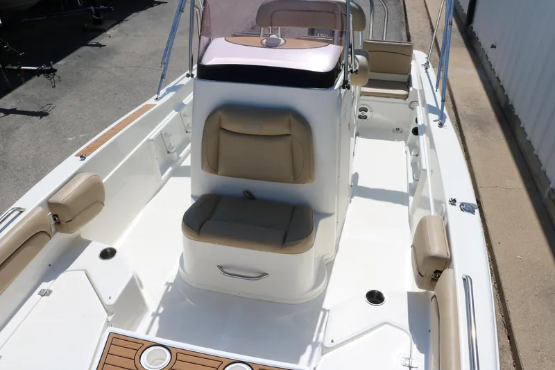 Slide: The Image of 2020 NauticStar 211 Hybrid boat dashboard with steering wheel and controls. - 23
