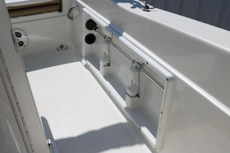 Slide: The Image of 2020 NauticStar 211 Hybrid boat interior with beige seating and white deck. - 24