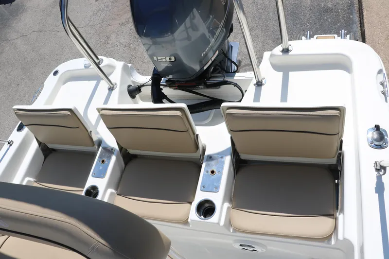 Slide: The Image of 2020 NauticStar 211 Hybrid boat seats and engine, featuring beige upholstery and a 150 horsepower motor. - 26